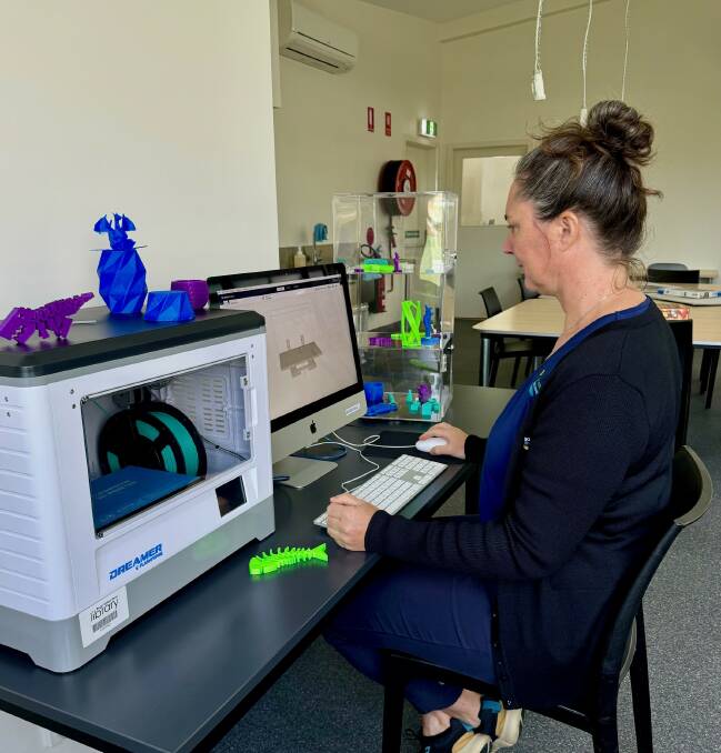 Willow at the Bermagui Library with the 3D printer and some of the items produced by the printer. Picture supplied