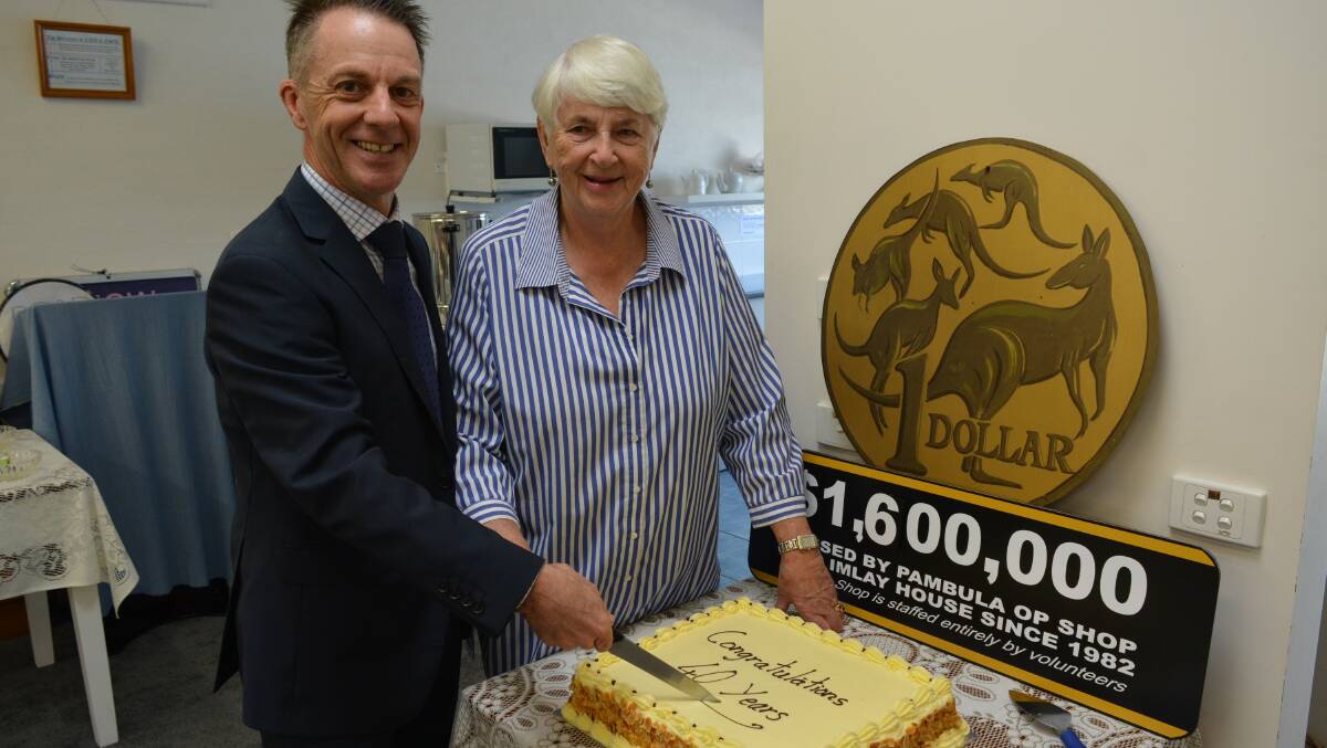 The then-Sapphire Coast Community Aged Care CEO Matt Sierp and Pambula op shop volunteer Alison Jenkins cut the store's 40th birthday cake in 2022. Picture by Ben Smyth