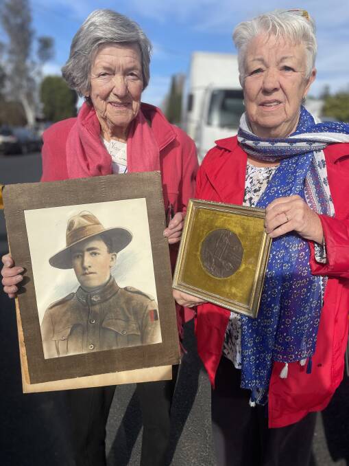 Gloria Cook and Cheryl Mathison with a portrait of Gloria's uncle, Eric Courtney Campbell, who died during service in WWI. Picture by Ben Smyth