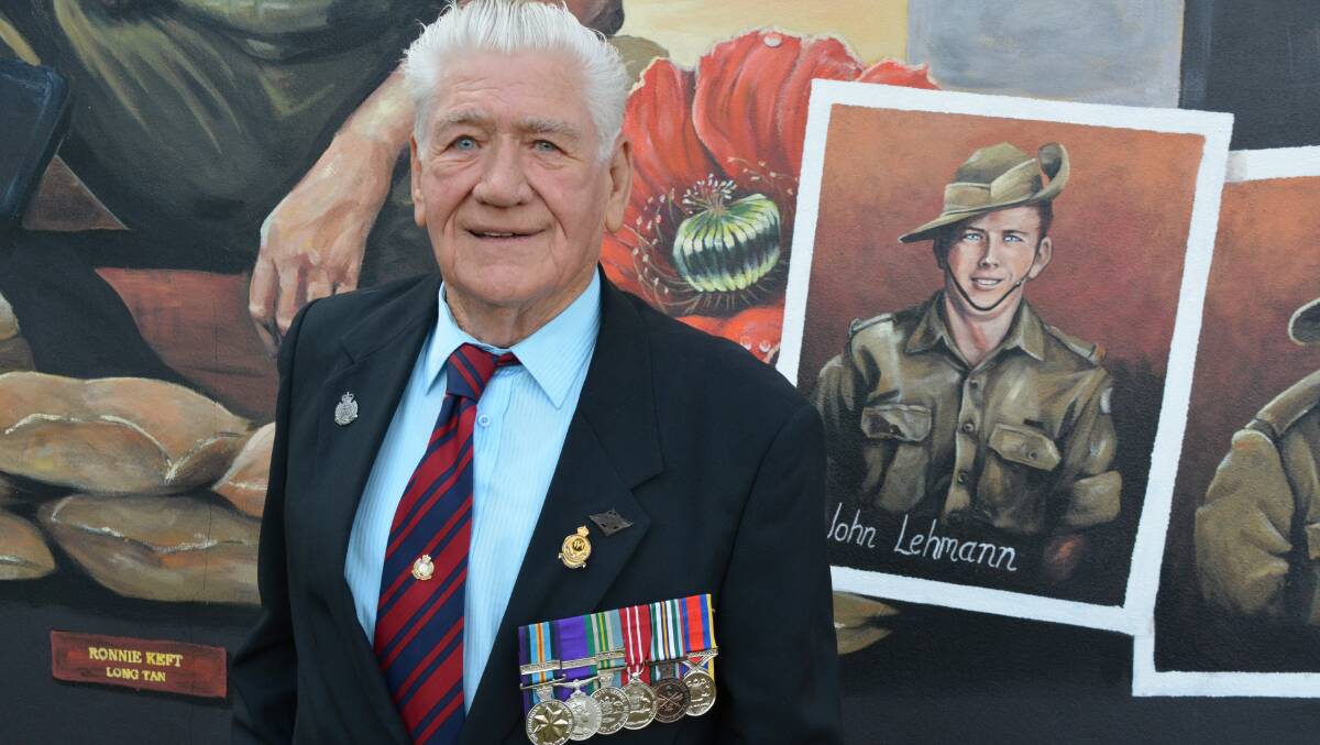 John Lehmann and the image of him as a young National Serviceman included in Terri Tuckwell's mural. Picture by Ben Smyth
