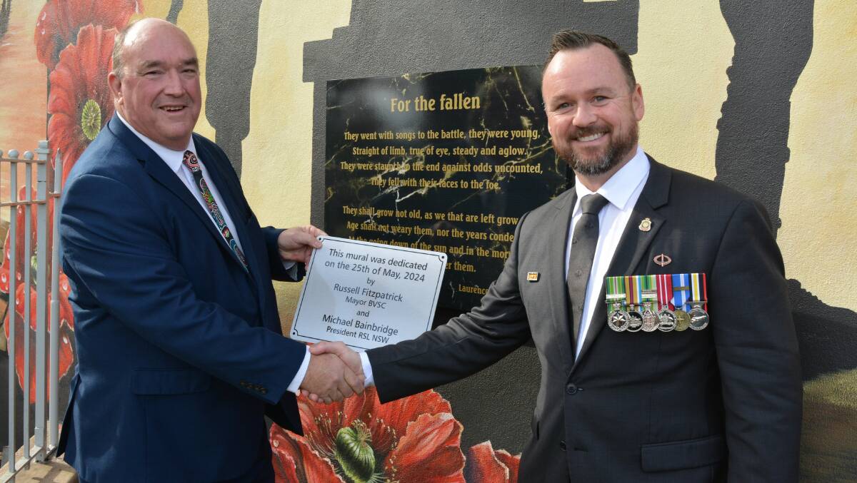 Mayor Russell Fitzpatrick and RSL NSW president Mick Bainbridge officially unveil and dedicate the soldiers' memorial mural in Bega. Picture by Ben Smyth