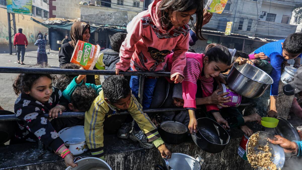 A charity organization distributes food to displaced Palestinians in the Gaza Strip. Picture Shutterstock