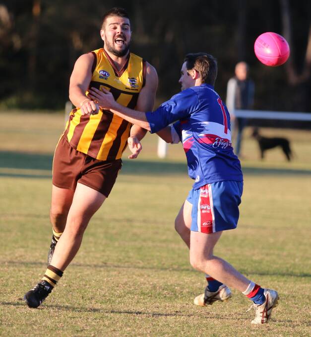 Close call: Johnno Di-Donato clears a handball before being tackled by Brendon Gordon in Saturday's senior match. 