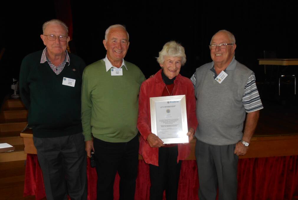 Recognition: Merimbula Probus Club life members Geoffrey Hayes, left, and Graham Waldon, right, with past president Simon Terry present Judy Crosbie, aka the Care Bear, with her life membership award. 